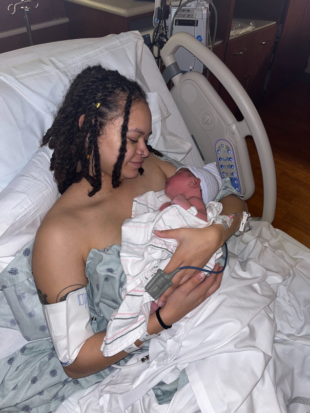 Deybrian holding her newborn daughter Zephaniah